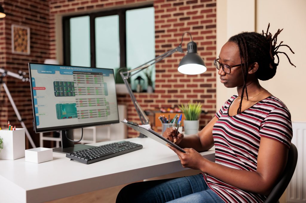 Woman analyzing business statistics, working with internet of things